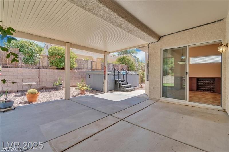 Image 3: Fenced backyard with a patio