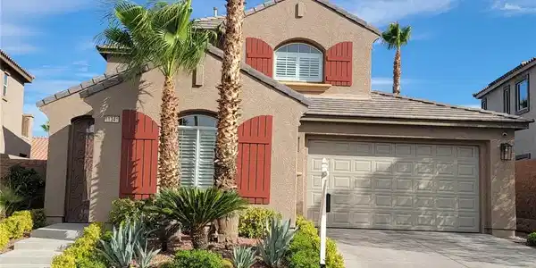 Image 2: Desert landscaping and decorative shutters frame t