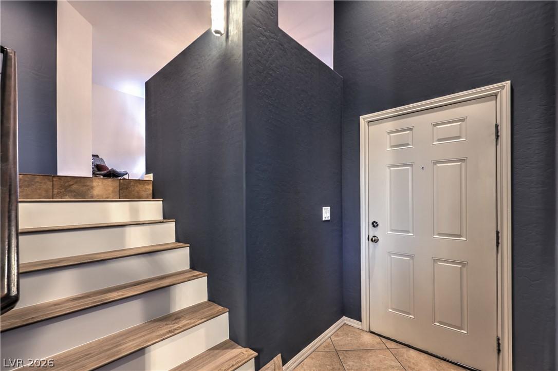 Image 3: A welcoming entryway with a contemporary front doo