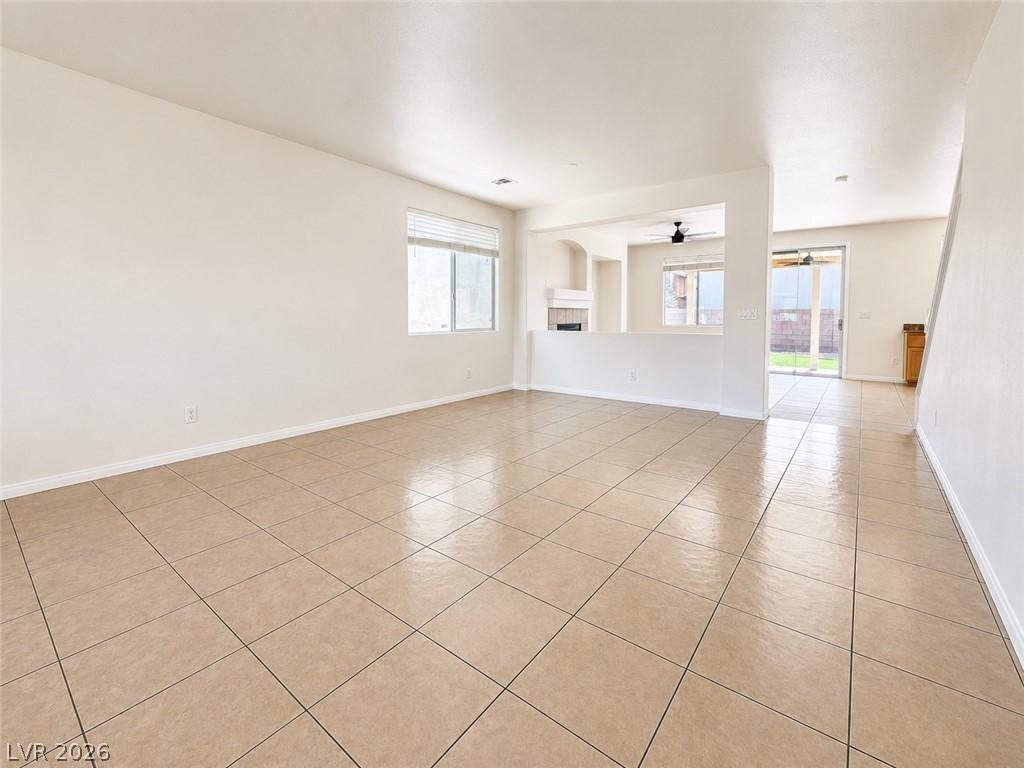 Image 2: Bright, open-concept living space with sleek tile