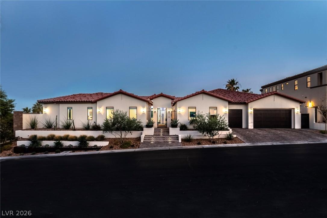 Image 3: A terracotta-tiled roof and desert landscaping cre
