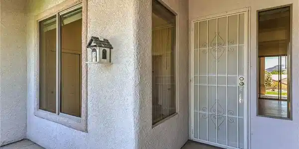 Image 3: Secure entry via a detailed metal security door, f