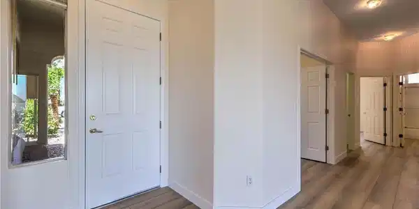Image 4: A well-lit entry hall with wood-look flooring and