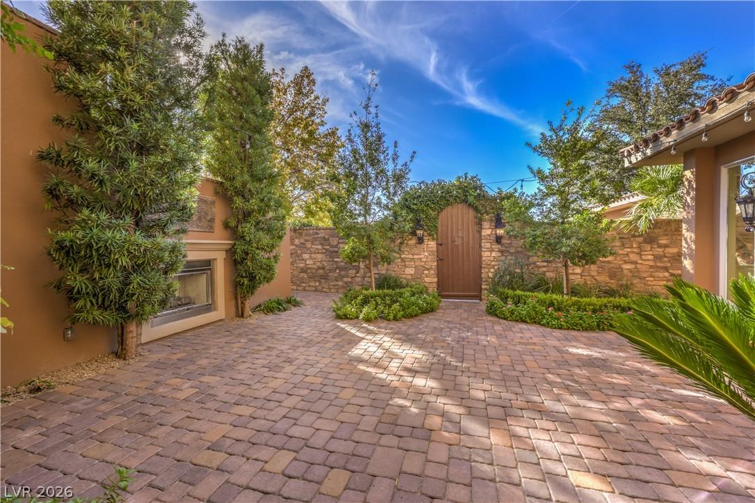 Image 3: A private outdoor space with a stone fireplace and