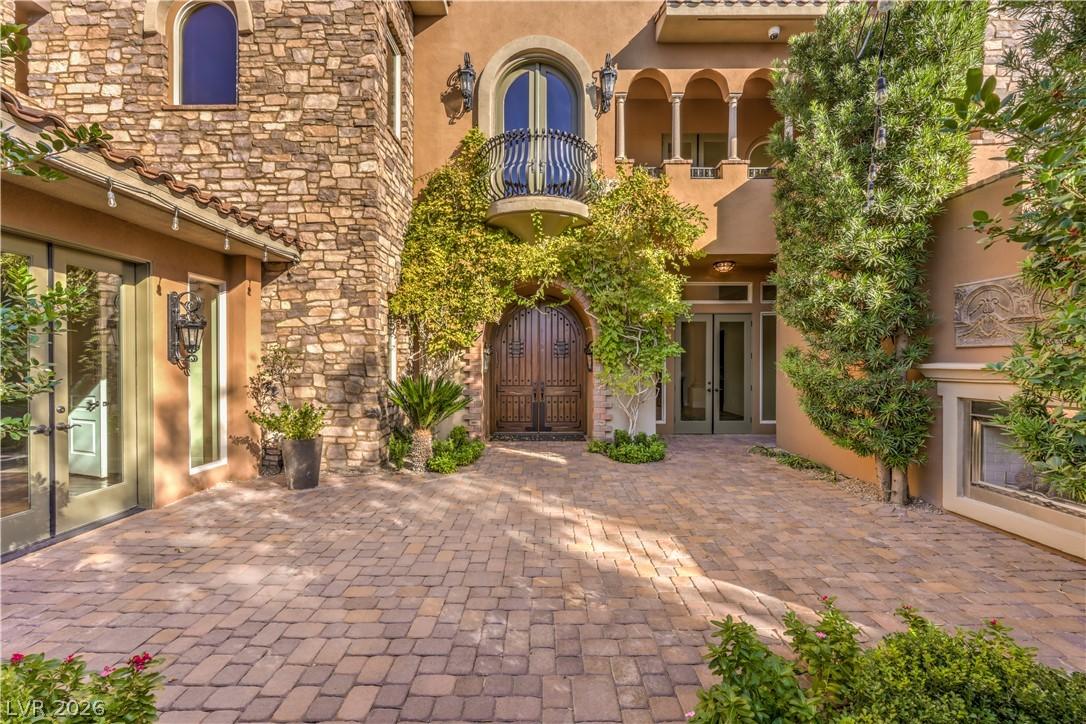 Image 4: Enter through a grand arched wooden door, flanked