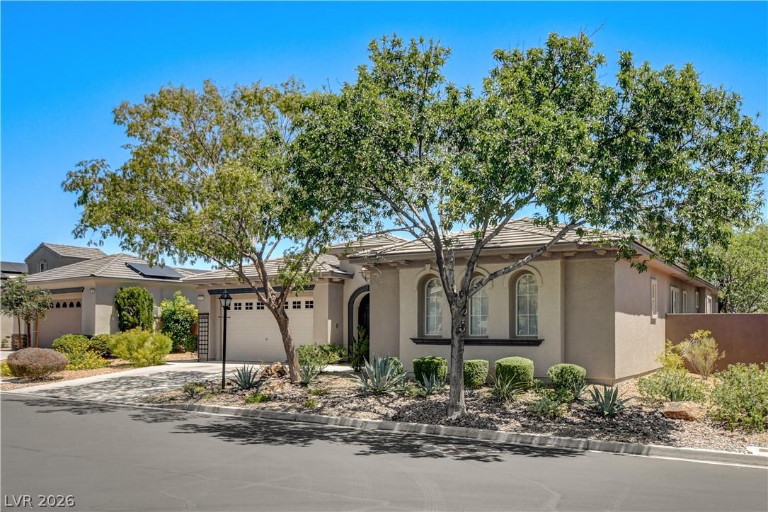 Image 2: A well-maintained stucco home with arched windows