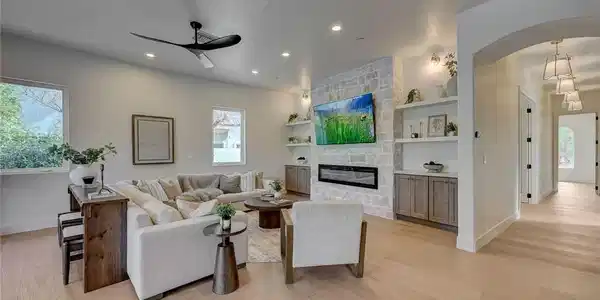Image 3: An inviting stone fireplace serves as the focal po