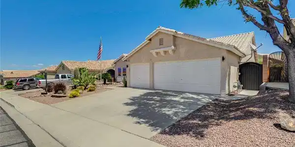 Image 4: This charming home offers a spacious driveway and