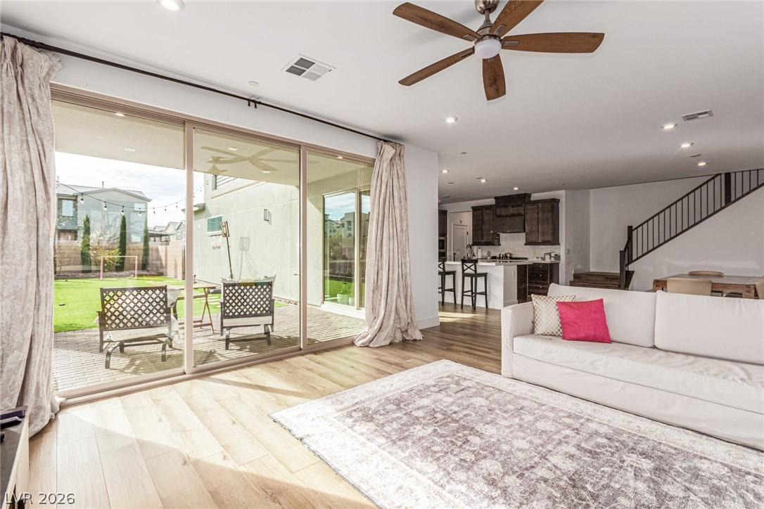 Image 4: Living room with a ceiling fan, light wood-style f