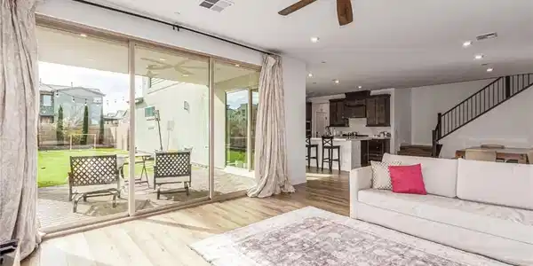 Image 4: Living room with a ceiling fan, light wood-style f