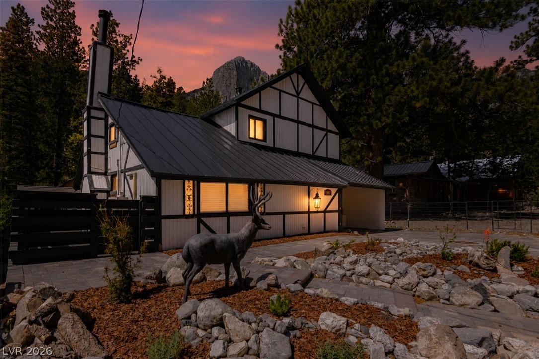 Image 4: A charming Tudor-style home nestled amongst toweri