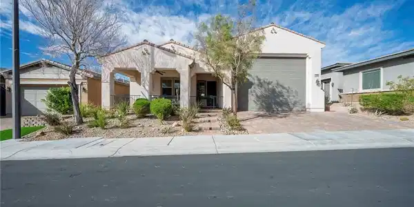 Image 4: Desert landscaping and a paved driveway frame this