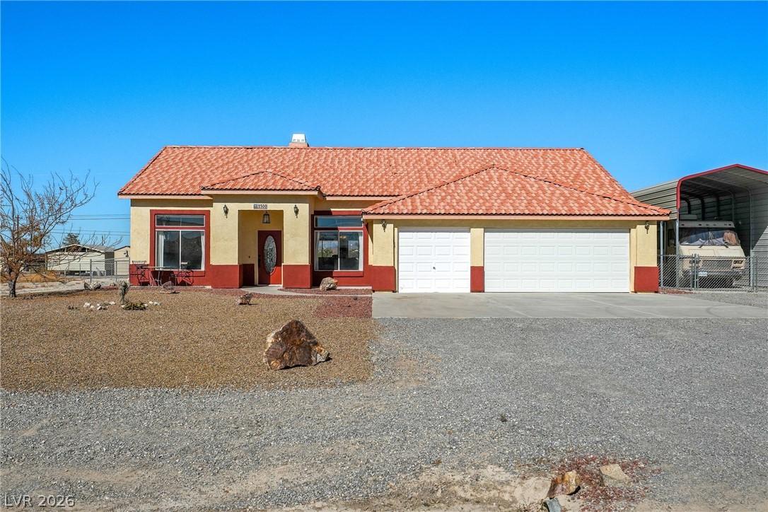 Image 1: This charming home features a classic tile roof an