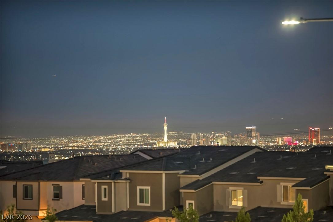 Image 3: City lights twinkle across the night, offering a v