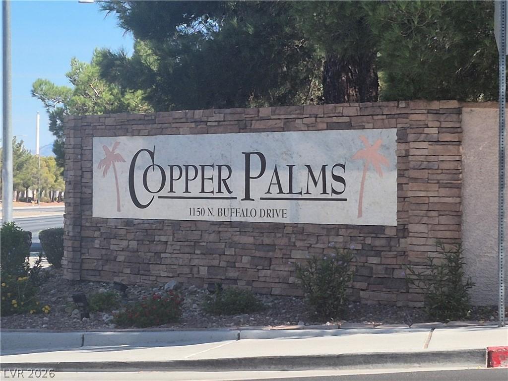 Image 1: A stone-clad monument sign anchors the entrance to