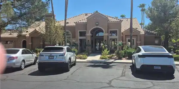 Image 2: An inviting entry framed by palm trees, featuring