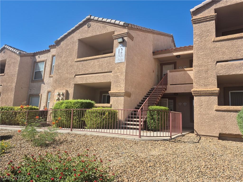 Image 3: A classic stucco exterior welcomes you to this mul