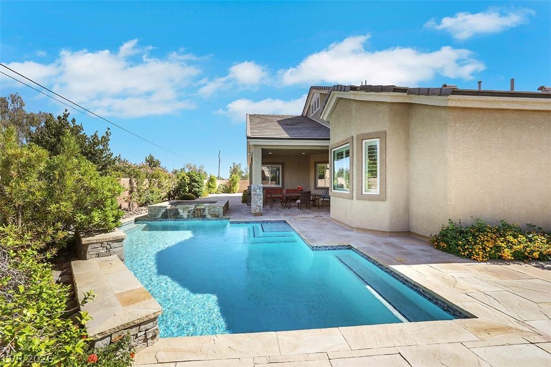 Image 2: An inviting backyard oasis offers a sparkling pool