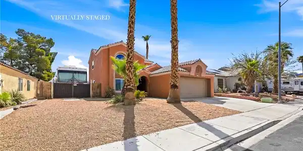 Image 3: Palm trees frame a desert landscape yard leading t