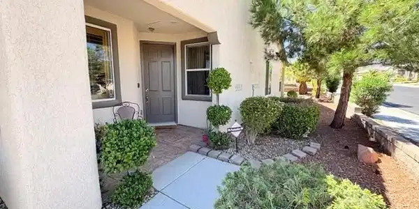 Image 4: Welcoming entryway framed by Lovely Landscaping.