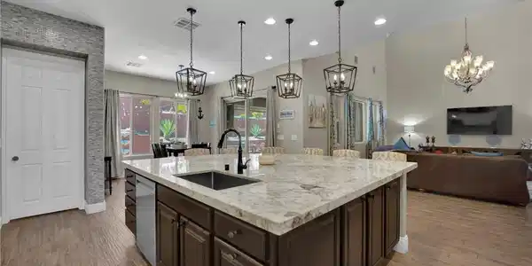 Image 2: Gleaming stone countertops and wood-look flooring