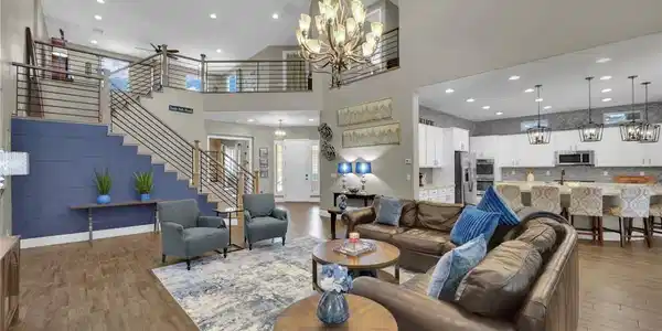 Image 3: Gleaming wood-look tile flooring and a grand stair