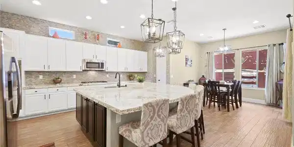 Image 4: Polished stone counters and durable wood-look tile