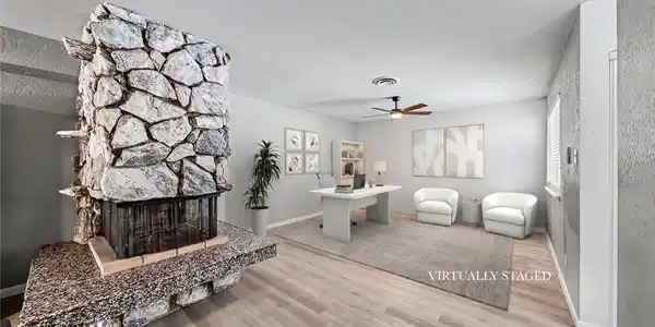 Image 2: An impressive floor-to-ceiling stone fireplace anc