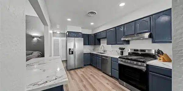 Image 4: Richly toned cabinetry meets stone-look countertop