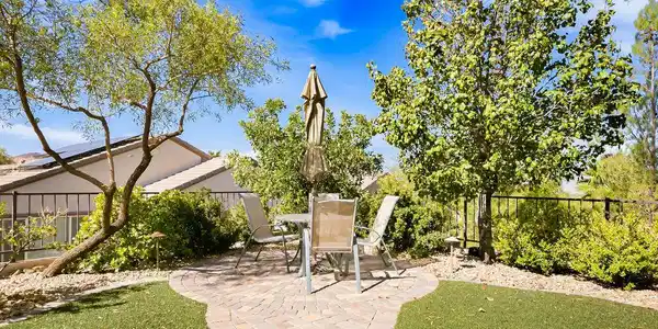 Image 4: A paved path leads to a circular patio space nestl