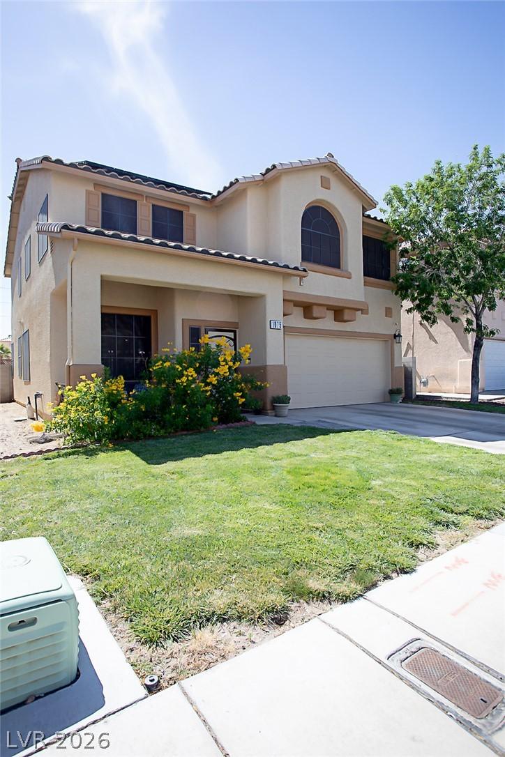 Image 2: A welcoming facade with a garage, inviting covered