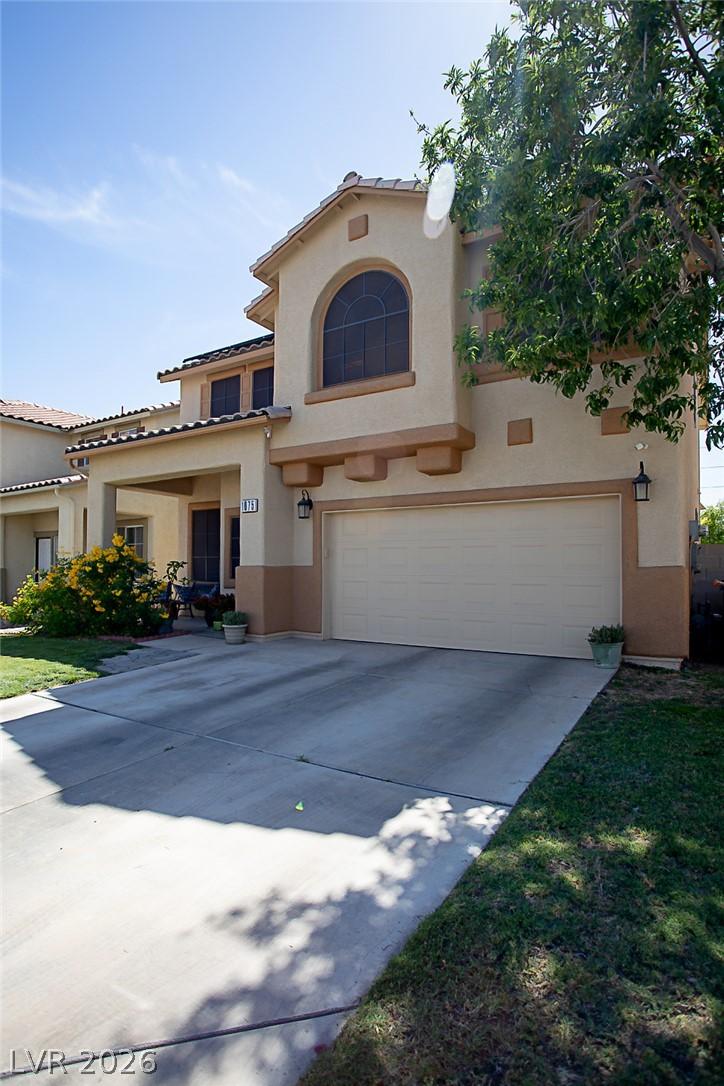 Image 3: A classic stucco facade with a large arched window