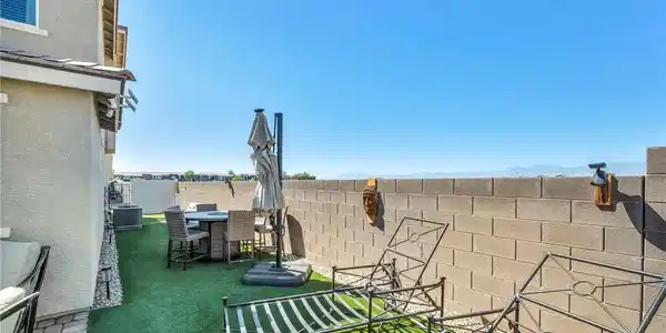 Image 4: An enclosed block wall surrounds this private yard