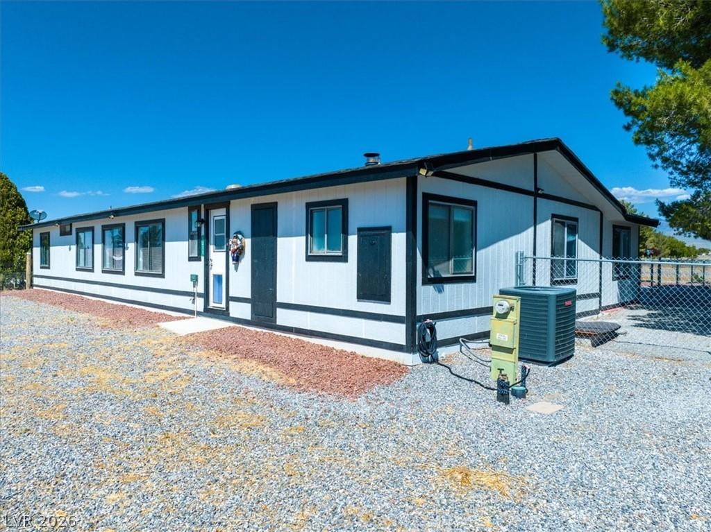 Image 3: This charming home offers a crisp exterior and a l