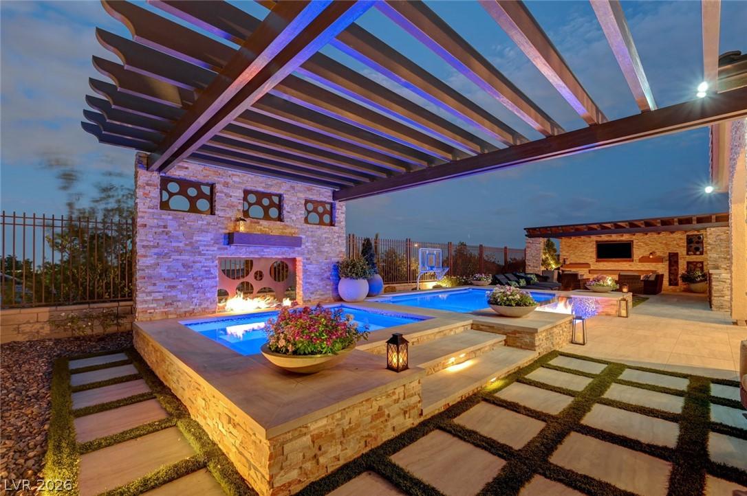 Image 2: An illuminated backyard oasis presents a multi-lev