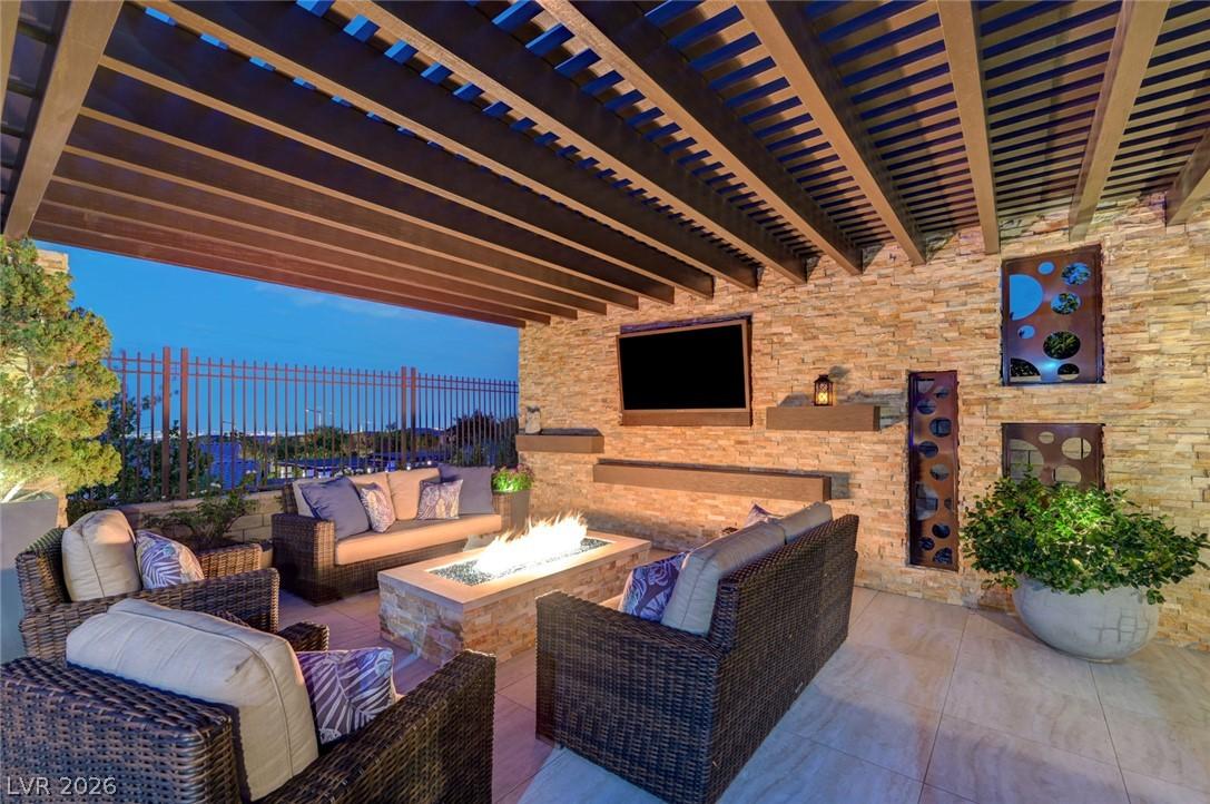 Image 3: An inviting outdoor living space features a cozy f