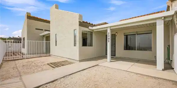 Image 4: Geometric stucco walls and a covered entry patio d