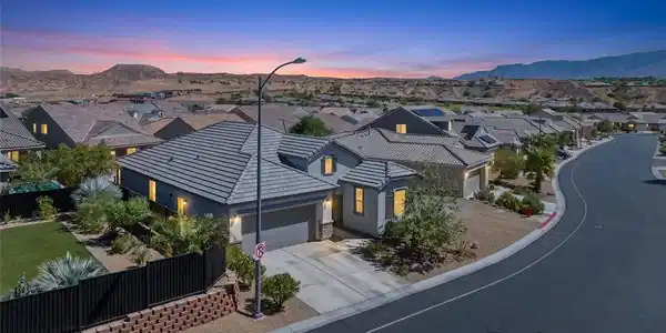 Image 2: A stylish stucco exterior and tiled roof command a