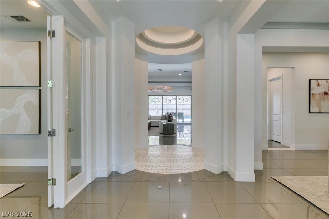 Image 3: A grand entrance with architectural curves leads t
