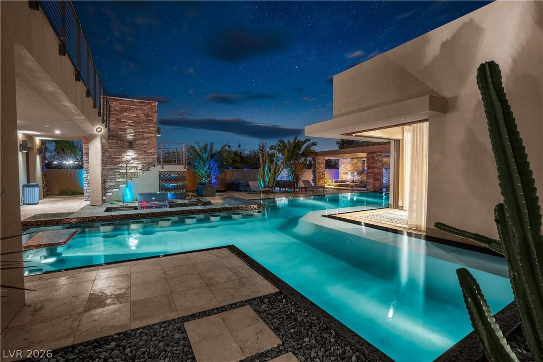 Image 4: An inviting exterior showcasing a luxurious pool a