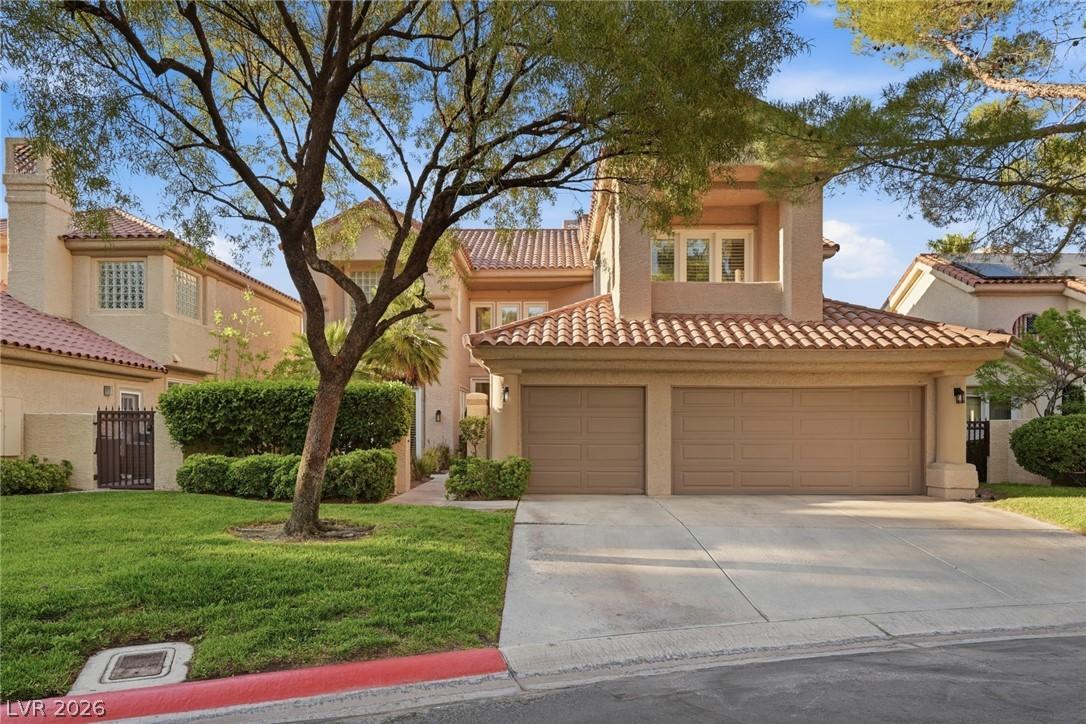 Image 1: Mature landscaping & beautiful trees frame this el