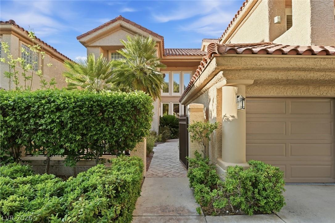 Image 4: A gated entrance with courtyard featuring manicure