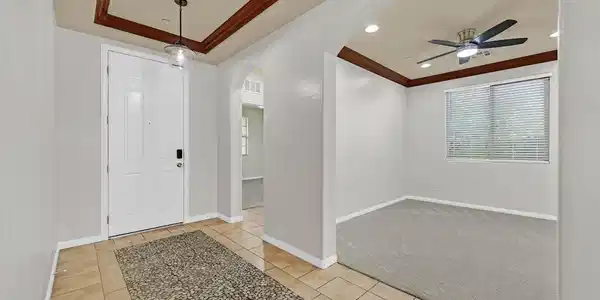 Image 3: Crown molding and arched entries frame a welcoming
