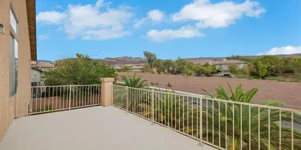 Image 3: An elevated terrace overlooks neighborhood rooftop