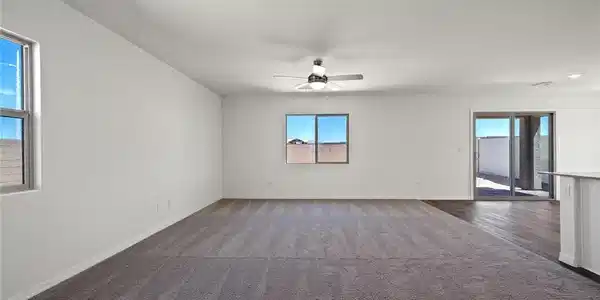 Image 2: Plush carpeting anchors this expansive living area