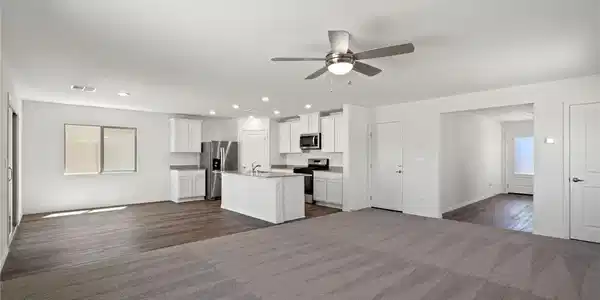 Image 3: An open floorplan seamlessly connects the carpeted