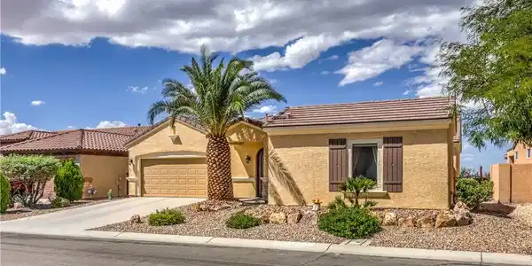 Image 3: Desert landscaping and a classic tile roof define