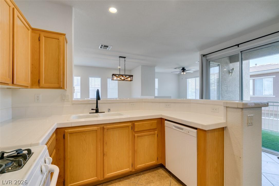 Image 4: A well-appointed kitchen features ample counter sp