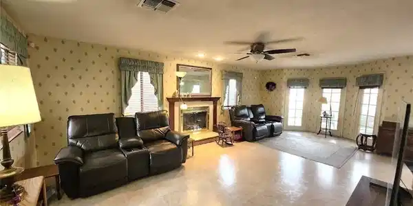 Image 4: A traditional living room offers a warm ambiance w