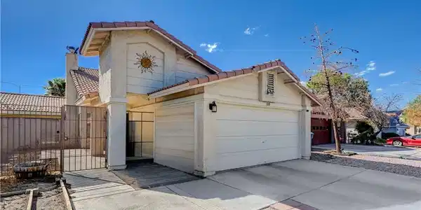 Image 4: An inviting facade features stucco walls, a tile r